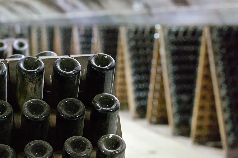 Champagne bottles are slowly turned by hand in the riddling process