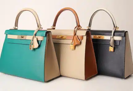 Assortment of Hermes luxury handbags, various colors of the "Kelly" bag