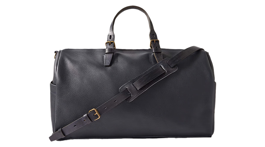 A black leather duffel bag with two short handles, gold-tone buckles, and an adjustable, detachable shoulder strap, set against a white background.