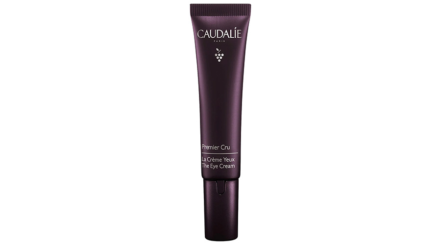 A dark purple tube of Caudalie Premier Cru The Eye Cream, standing upright with a pointed cap and white text on the front.
