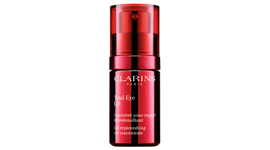 A red bottle of Clarins Paris Total Eye Lift, a lift-replenishing eye concentrate, with white text and a pump dispenser.