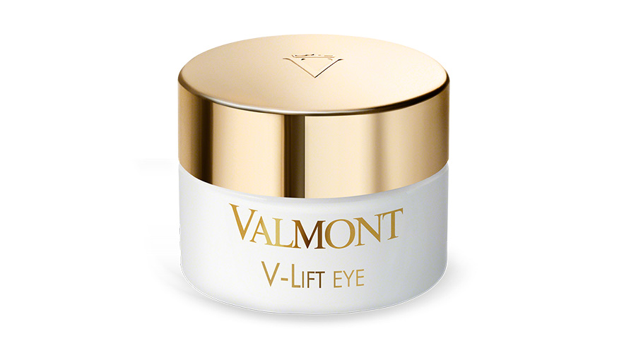 A white jar with a shiny gold lid labeled VALMONT V-LIFT EYE, containing an eye cream. The lid has a subtle logo, and the container is set against a plain white background.