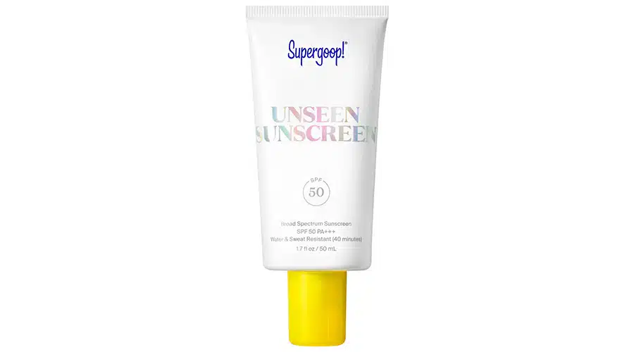 A tube of Supergoop! Unseen Sunscreen SPF 50 with a white body, yellow cap, and colorful text, photographed against a white background.
