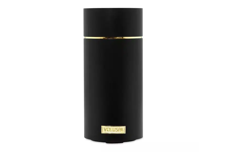 A sleek black cylindrical container with a gold accent near the top and a gold Voluspa label near the bottom, set against a plain white background.