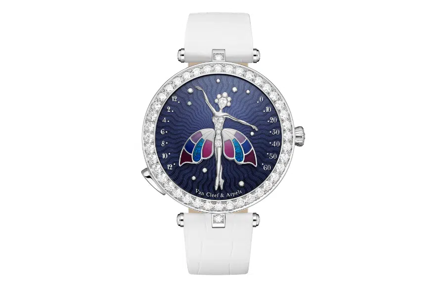 A luxury wristwatch with a white strap, diamond-encrusted bezel, and a dark blue dial featuring a ballerina with butterfly wings in colorful enamel. The watch face is marked with the Van Cleef & Arpels logo.