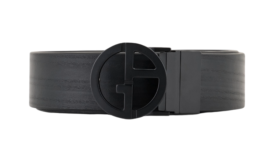 A black leather belt with a round, black metal buckle featuring a bold, stylized G design. The belt is rolled up, showcasing the textured leather and prominent buckle at the front.