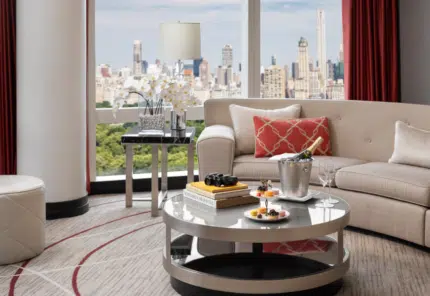 Inside a luxurious suite at the Mandarin Oriental, hotel in New York. Offering cozy high-end furniture, and a beautiful view of New York City