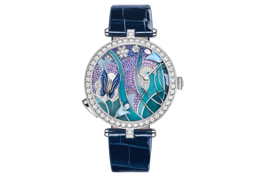 A luxurious wristwatch with a blue leather strap, diamond-studded bezel, and a detailed dial featuring butterflies, flowers, and blue and purple accents in an artistic, nature-inspired design.
