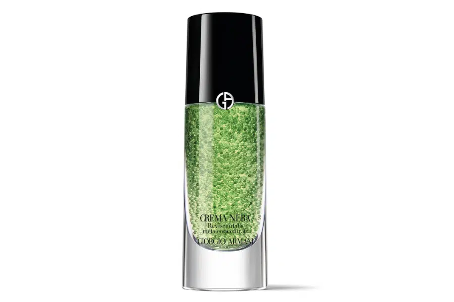 A clear bottle of green gel skincare serum with a black cap, featuring the Giorgio Armani logo and the label “CREMA NERA Reviving Volcanic Mask” on the front.