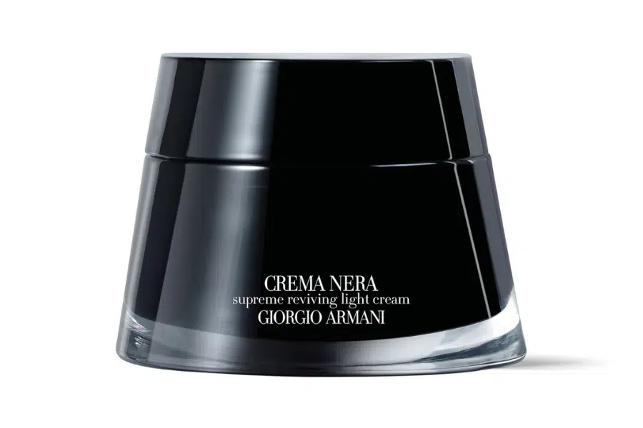 A black, glossy jar of Giorgio Armani Crema Nera Supreme Reviving Light Cream with white text branding on the front, set against a plain white background.