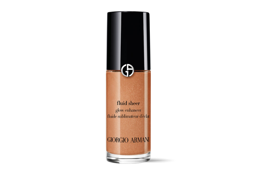 A bottle of Giorgio Armani Fluid Sheer Glow Enhancer with a shiny black cap, transparent body showing a shimmery bronze liquid, and black text on the front of the bottle.