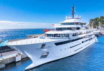 A docked large yacht with helipad, multiple decks, and high luxury