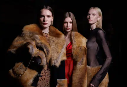 Three female models showcasing luxurious Italian-designer outfits