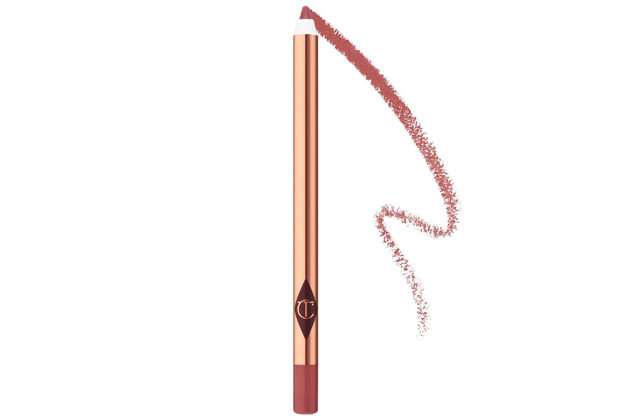 A rose gold lip liner pencil with a pink tip, shown drawing a soft, wavy pink line on a white background.