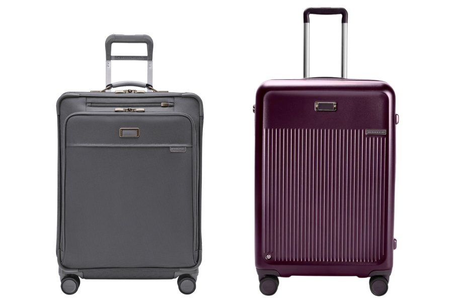Two upright suitcases with telescoping handles and four wheels each: one is soft-sided and gray with front pockets, the other is hard-shell and purple with a ribbed design. Both are standing on a white background.