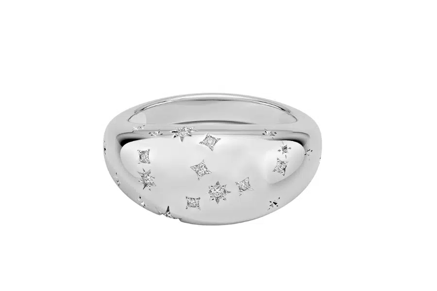 A shiny silver dome-shaped ring with small, scattered square and round-cut diamond accents embedded in its smooth surface.
