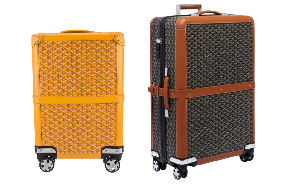 Two luxury hard-shell suitcases with wheels, one in yellow with a patterned surface, and the other in black and brown with a geometric design and leather trim, both standing upright.