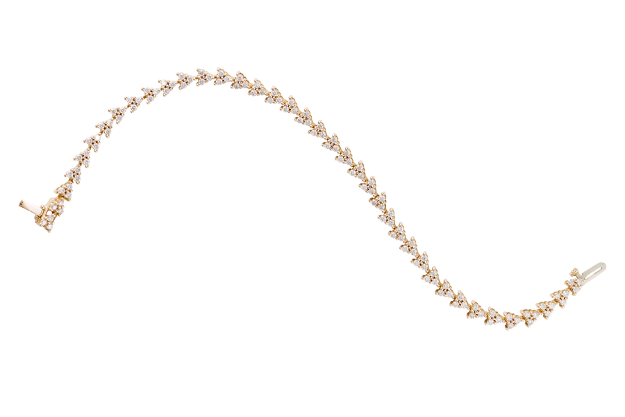 A gold tennis bracelet with a wavy shape, featuring a row of small, sparkling diamonds set closely together along its length, isolated on a white background.