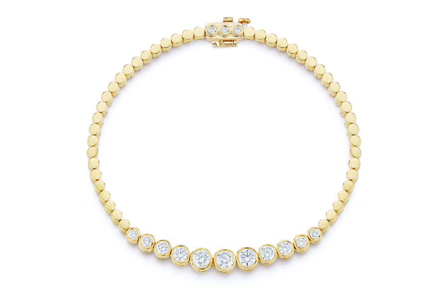 A gold necklace with a series of round gold links, featuring larger round diamonds set at the front and a clasp at the top.