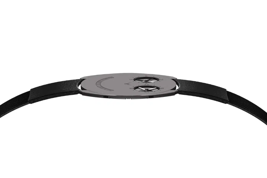 A minimalist wristwatch with a thin black strap, seen from the side. The watch has a sleek, flat face with two small, raised circular dials and subtle engraved marks. The background is plain white.
