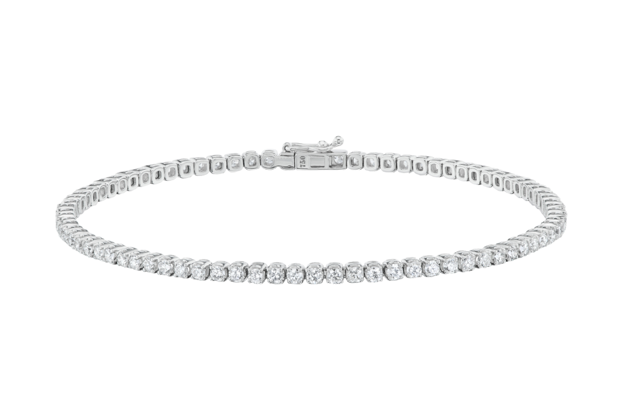 A delicate white gold tennis bracelet featuring a single row of sparkling round diamonds, shown on a plain white background.