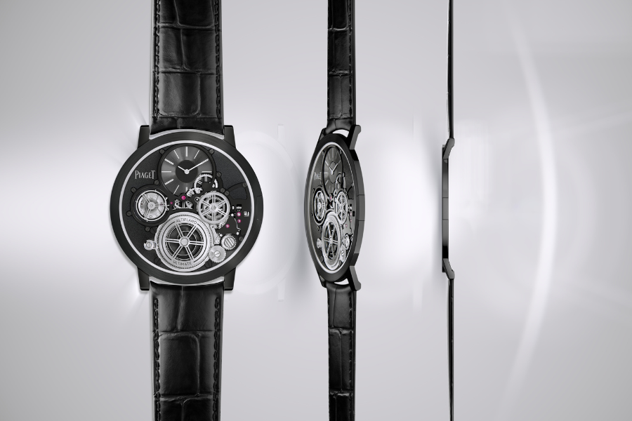 A luxury watch with a black leather strap and visible internal gears is shown from three angles: front, diagonal, and side, highlighting its ultra-thin design and intricate mechanical details against a light background.