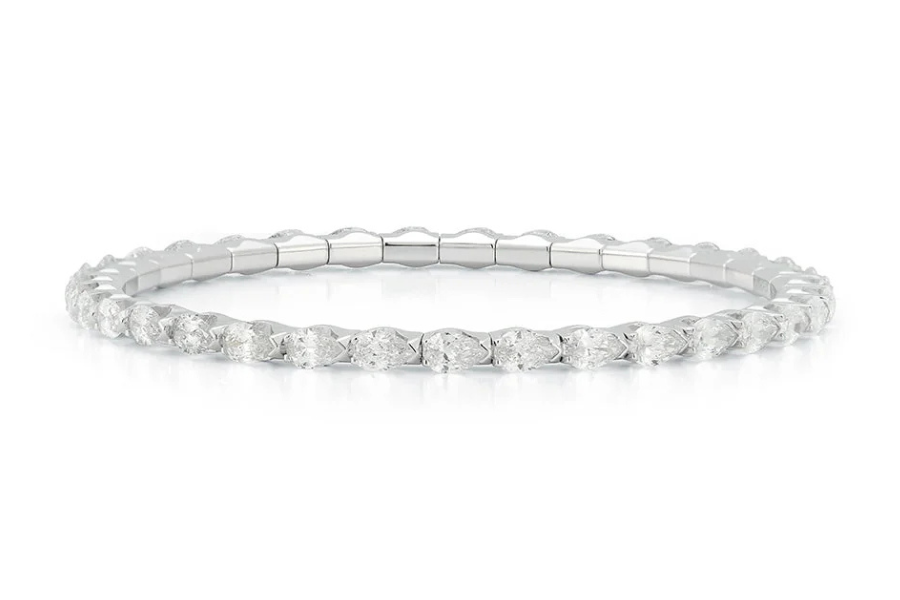 A delicate, thin white gold or platinum eternity band set with small round-cut diamonds all around. The ring is displayed on a white background.