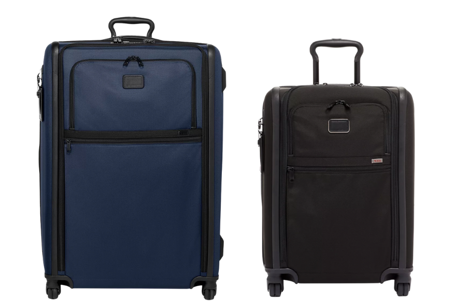 Two upright rolling suitcases stand side by side, one blue and one black, both with front zippered pockets, telescoping handles, and four spinner wheels, photographed on a white background.