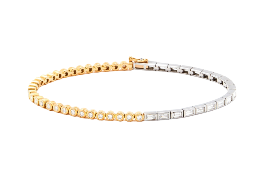 A half gold, half silver tennis bracelet; the gold section features round diamonds in bezel settings, and the silver section features rectangular settings with baguette-cut diamonds.