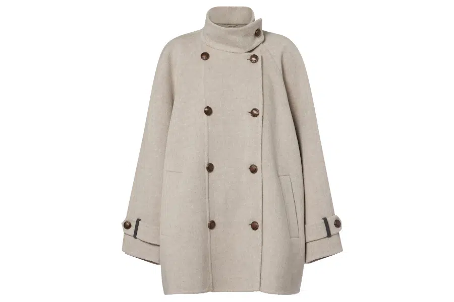 A beige, double-breasted wool coat with large brown buttons, wide sleeves, and a high collar. The cuffs have buttoned straps and dark trim detailing.