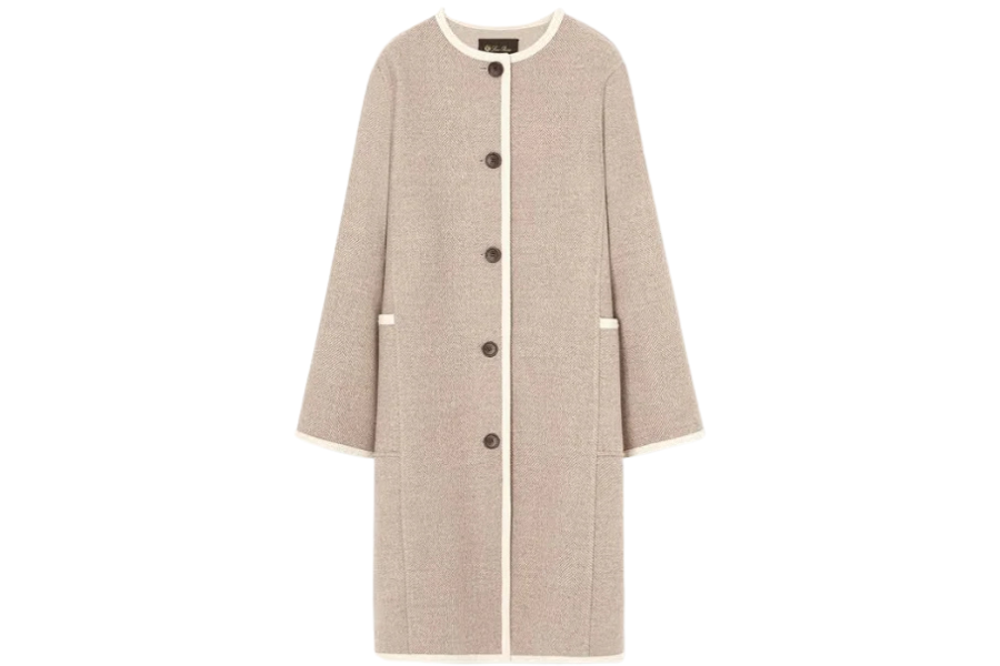 A long, light beige coat with white trim, five dark buttons down the front, and two front pockets. The coat has a round neckline and a straight, loose fit.
