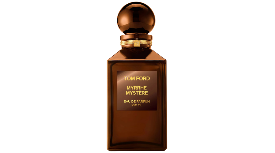 A brown glass bottle of Tom Ford Myrrhe Mystère Eau de Parfum, featuring a round cap and a gold label with the product name and size in gold lettering on the front.