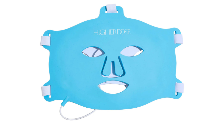 A blue silicone face mask labeled HIGHERDOSE, with cutouts for the eyes, nose, and mouth, and adjustable white straps on the sides. A white cord is attached to the bottom left corner.
