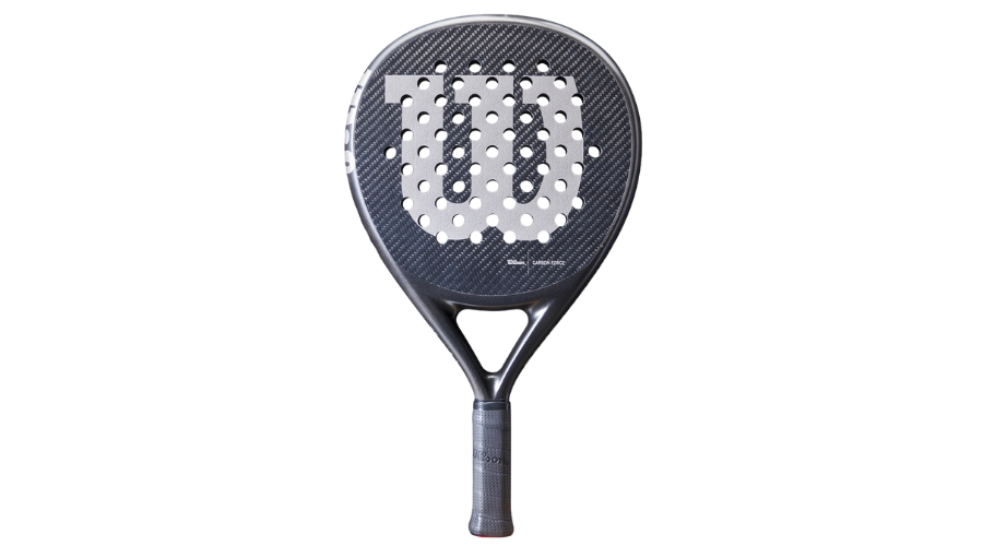 A black padel racket with a large white W logo on the face, featuring perforated holes and a textured carbon fiber surface. The handle is wrapped with a grip for comfortable holding.