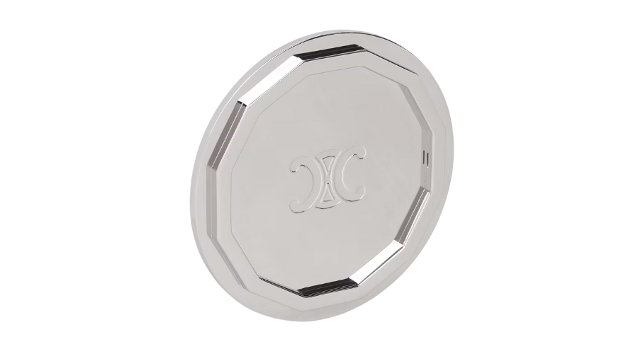 A round, silver-colored tray with a raised edge and a geometric border, featuring an engraved decorative double-C logo in the center on a white background.