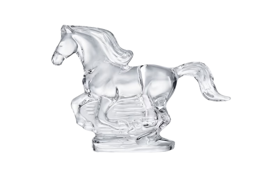A clear glass sculpture of a galloping horse, shown in profile with one front leg raised, set against a white background.