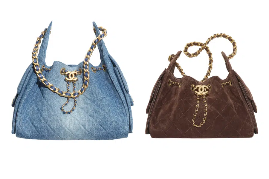 Two quilted handbags with gold chain straps and gold CC logos; one bag is light blue denim, and the other is dark brown suede, both set against a white background.