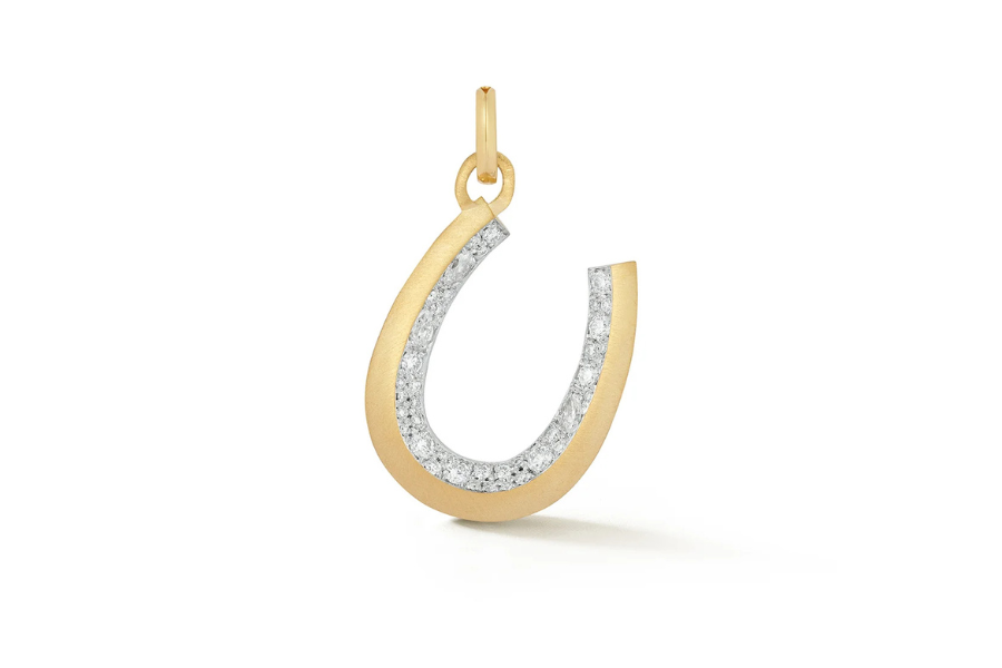 A gold horseshoe-shaped pendant with a row of sparkling diamonds along the inner curve, attached to a small gold loop at the top, displayed on a white background.