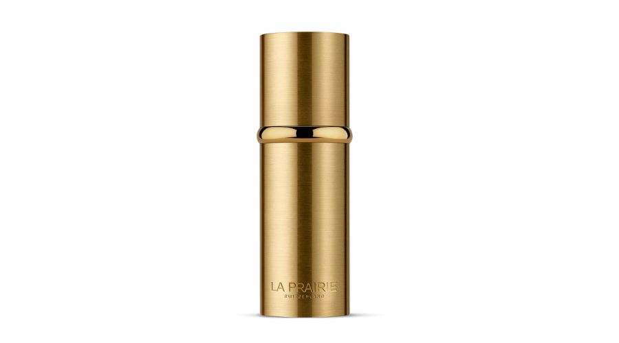 A cylindrical, gold-colored bottle with a metallic finish and the brand name La Prairie printed near the base, against a white background.