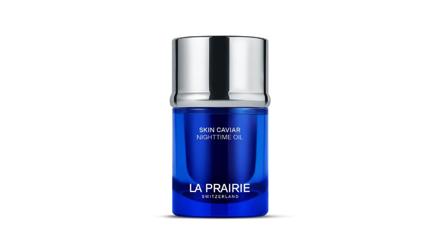 A blue and silver bottle labeled La Prairie Switzerland and Skin Caviar Nighttime Oil stands centered on a white background.