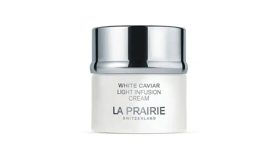 A jar of La Prairie White Caviar Light Infusion Cream with a shiny silver lid and white container, featuring the brand and product name in gray text on the front.