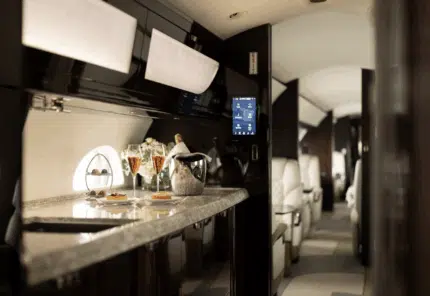 Luxury private jet interior with cocktail bar and kitchen - by FLEXJET